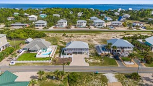A coastal residential area with houses, a swimming pool, and a beach. - The Extra Mile, One Level, 2BR, Great for couples or small families! (Saint George Island)