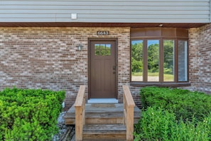 Stunning residential building with a brick facade and a welcoming front door.
