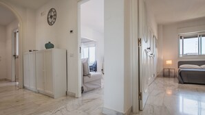 A spacious room with a marble floor, a bed, a bedside table with a lamp, and a wardrobe. - Europa Landscape by Wonderful Italy (Catania)
