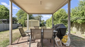 Relax outdoors with a covered seating area, complete with a grill and firewood available.