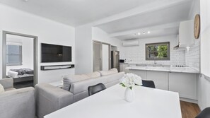 Relax in this compact living space with a flat-screen TV, kitchenette, and dining area.