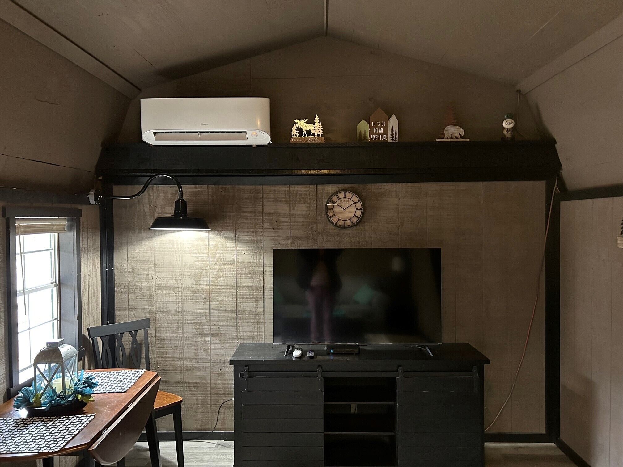 A room with a desk, chair, and a fireplace.
