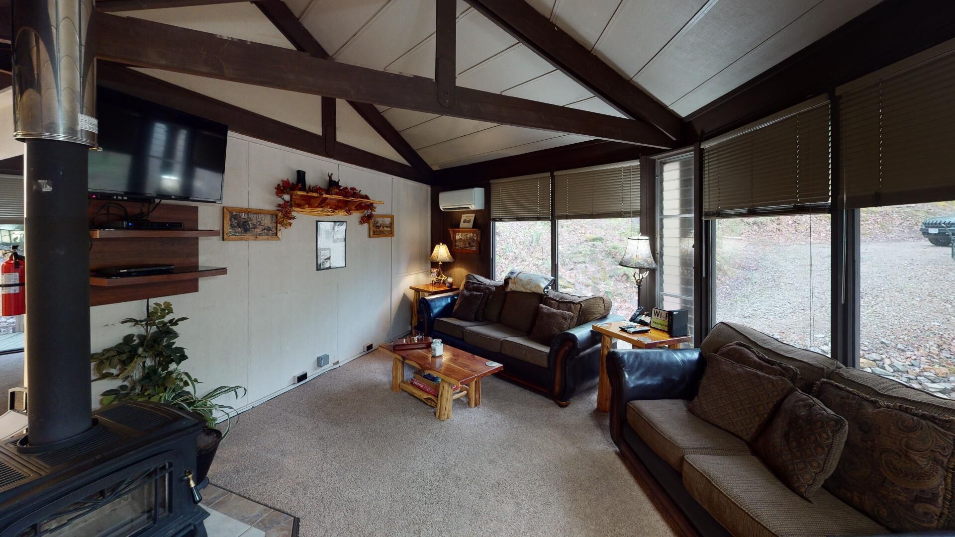 living room with wood burning stove for a cozy fire