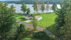 A house with a fenced yard and a view of a lake.