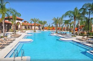 A large outdoor swimming pool with multiple lanes, surrounded by palm trees and lounge chairs. - "Best Vrbo Ever" Massive-Popular-Pool-Spa-Game Rm-Home Theater-Disney Sleep 30 (Davenport)