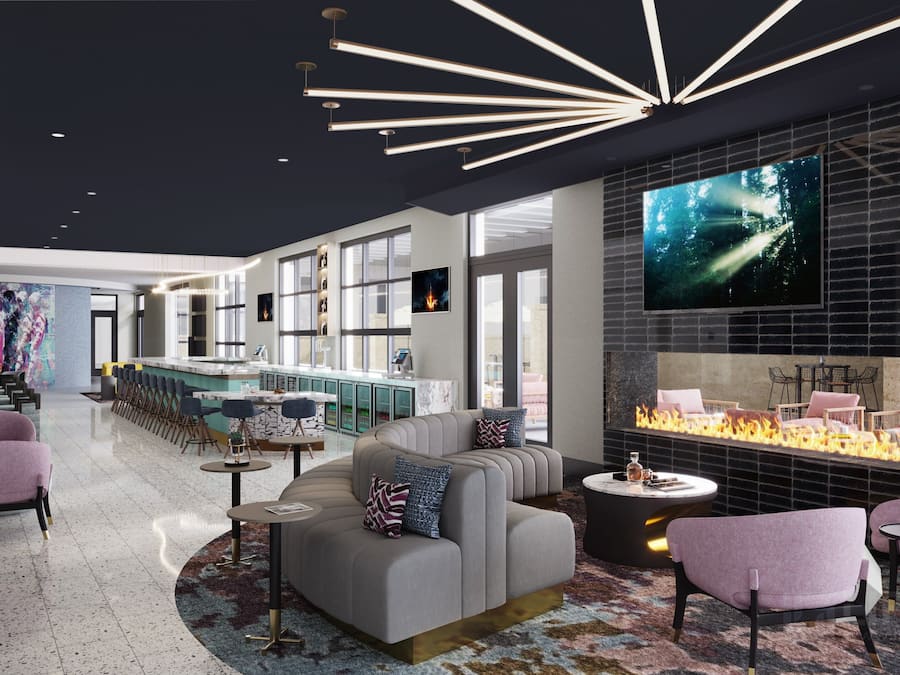 Ein stilvoller Lounge-Bereich mit Bar, Sitzgelegenheiten und Kamin.
