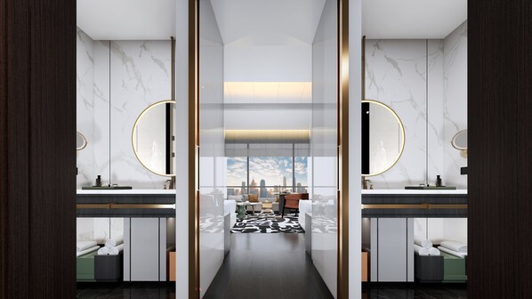 A modern bathroom with two sinks, marble walls, and a city view.