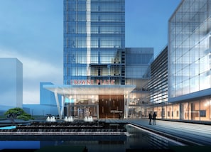 Un edificio moderno con fachada de vidrio y un letrero que dice "CROWNE PLAZA".