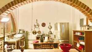 A kitchen with an arched brick ceiling, stainless steel appliances, and various kitchen utensils. - Room #2 two blocks from the Malecon (La Paz)