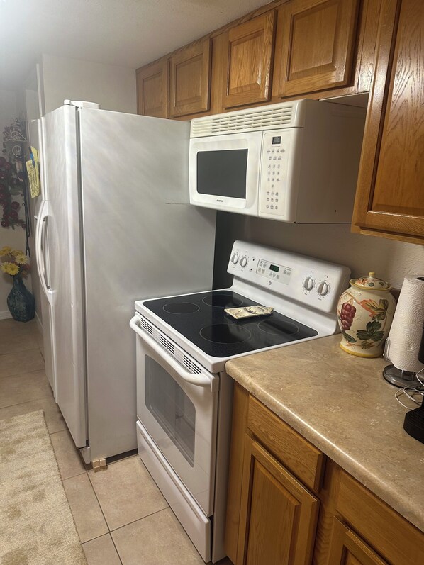 A kitchen with a refrigerator, microwave, stove, and oven. - Beautiful Condo with balcony, Steps to private beach!
secure gated community ! (St. Petersburg)