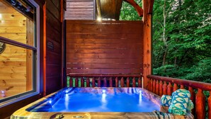 A wooden hot tub with a wooden deck and railing, surrounded by a forest. - Log Cabin Retreat in the Smoky Mountain:Private Hot Tub, Billiards, Arcade Games (Gatlinburg)