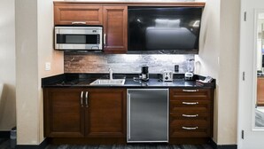 A compact kitchen with a microwave, toaster, and dishwasher. - PH Floor Studio • Strip View • Balcony • No Resort Fee D30O3 (Las Vegas)