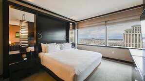 A modern hotel room with a large bed, a desk, and a view of the cityscape. - Vdara Studio • City View • Free Valet • Pool • L20 (Las Vegas)