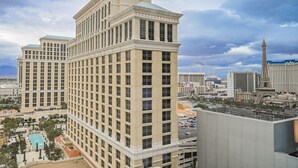 A high-rise hotel with a classic architectural style, featuring a central courtyard with a swimming pool and multiple balconies. - Vdara Studio • City View • Free Valet • Pool • L20 (Las Vegas)