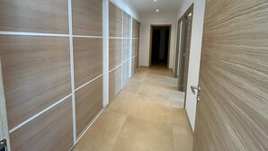 A hallway with sliding doors and a tiled floor. - LABELLE- PANORAMIC SEA VIEW- PRIVATE POOL- AIR CONDITIONING-WIFI (SARI-SOLENZARA)