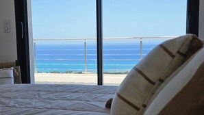 A bedroom with a large window overlooking a beach. - LABELLE- PANORAMIC SEA VIEW- PRIVATE POOL- AIR CONDITIONING-WIFI (SARI-SOLENZARA)