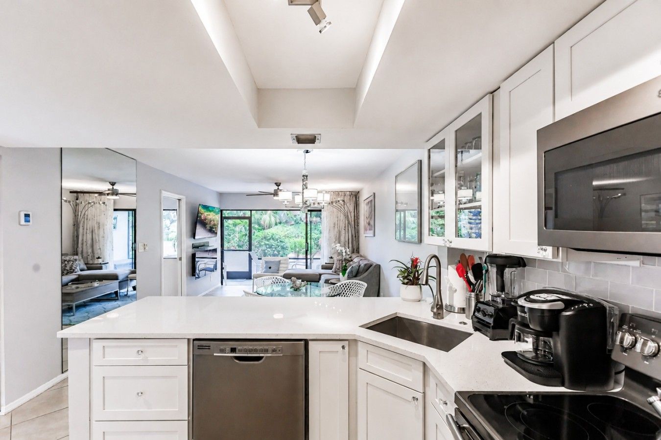 A modern kitchen with a dishwasher, stove, and microwave.