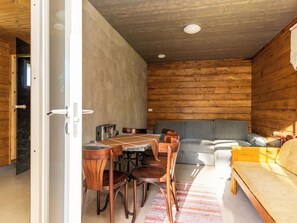 Een gezellig interieur met een eethoek, bank en een bed.