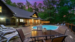 A wooden cabin with a pool and deck chairs. - Wild Oasis · New! Wild Oasis: Pool, Gameroom, Theatre, Hot Tub (Broken Bow)