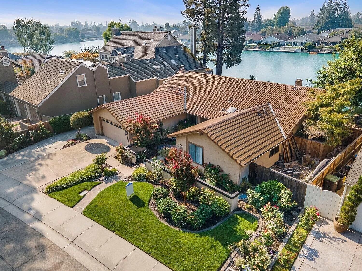 Cozy Home on a Lake and a sparkling pool with lush garden and Dock!