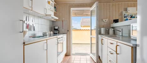 Fridge, stovetop, dishwasher, coffee/tea maker