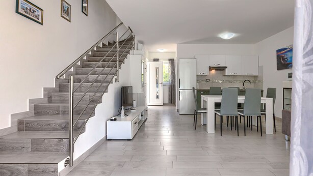 A modern kitchen with white cabinets, a built-in oven, and a refrigerator. - Villa Oli/A by Interhome (Medulin/Ližnjan)