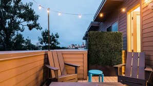 An outdoor seating area with chairs, a table, and a fire pit.