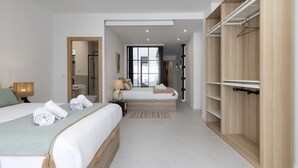 A modern hotel room with two beds, a walk-in closet, and a bathroom with a shower. - My Loft 4 You Patraix Style (Valencia)