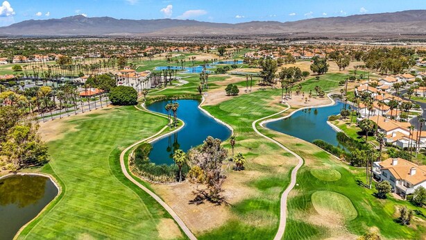 A golf course with multiple ponds and a residential area in the background. - Near Coachella Two Bedroom Two Bath Condo, Steps from the Pool & Spa, Desert Falls CC (Palm Desert)