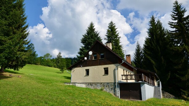 A two-story chalet with a stone foundation, a balcony, and a chimney. - Vacation home Hoja by Interhome (Vítkovice)