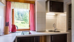 A kitchen with a window, a sink, and a cabinet. - Vacation home Hoja by Interhome (Vítkovice)