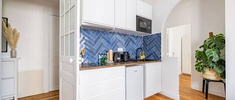 Fridge, microwave, coffee/tea maker, cookware/dishes/utensils