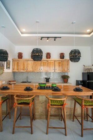 Enjoy cooking in this well-equipped kitchen with a central island, bar stools, and ample storage.