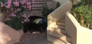 A stone bridge, a staircase, and pink flowers.