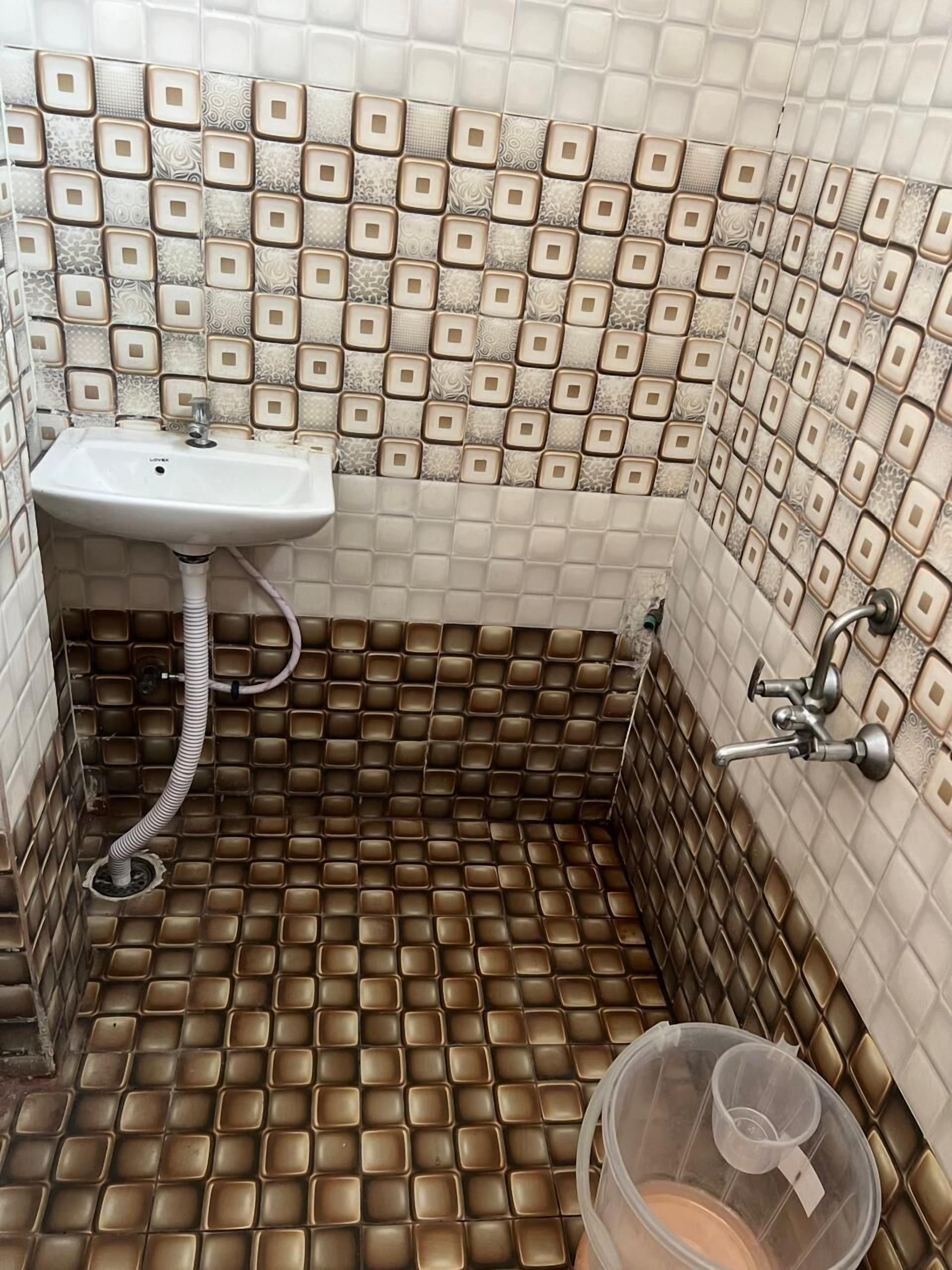 A bathroom with a sink, a shower, and a toilet.