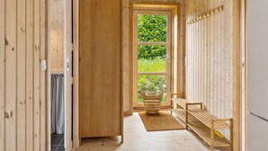 A wooden interior hallway with a door leading to a garden. - "Skamhals" - 440m to the fjord by Interhome (Frederiksværk)