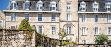 A large stone building with multiple windows and a central entrance.