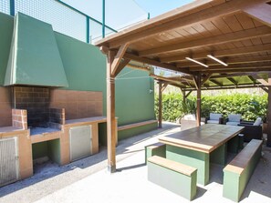 Enjoy al fresco dining on the patio with a grill and comfortable seating.