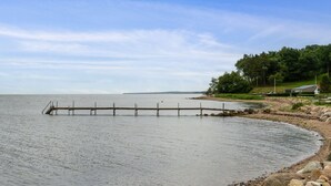 A calm lake with a wooden dock extending into the water.
