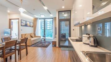 A modern kitchen with a built-in oven, a coffee maker, and a sink.