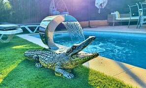 A crocodile-shaped lounge chair by a pool with a clear view of the water. - APARTMENT WITH PRIVATE POOL AND SEA VIEWS
 (Lloret de Mar)