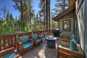 A deck with wooden furniture, a fire pit, and a grill. - PET FRIENDLY! Game Room! Fire Pit! Decks! Fenced Yard! (Big Bear Lake)