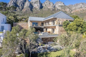 Enjoy a scenic view of the rugged mountains from the spacious outdoor area, featuring a patio and pool.