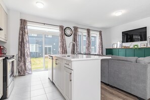 Fridge, microwave, oven, stovetop - The Green Bohemian: 3-bedroom furnished mid-term rental, 3mins to CanTire Centre (Ottawa)