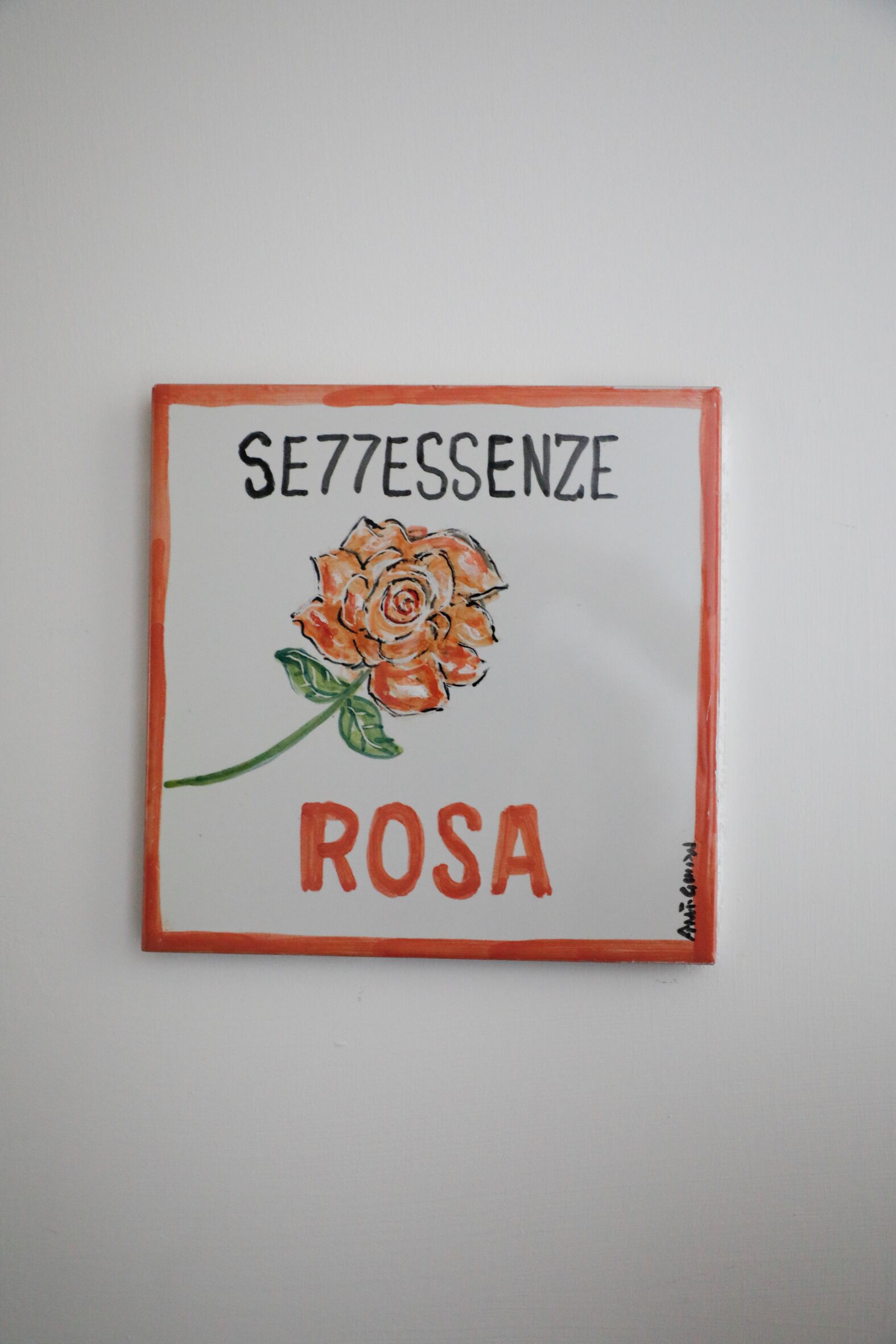 Una obra d'art emmarcada amb una rosa i text.