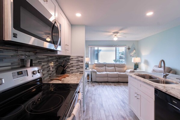 A modern kitchen with a built-in microwave, stove, and dishwasher.
