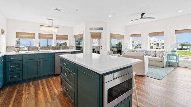 A spacious kitchen with a large island, dark cabinetry, and a view of the outdoors. - Twist of Lime - Mexico Beach, Unobstructed Gulf view, Elevator, Private Pool, Tw (Mexico Beach)