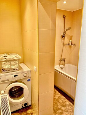 Combined shower/bathtub, towels, soap, toilet paper