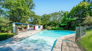 A swimming pool with a covered area, surrounded by trees and a fenced enclosure. - Pet friendly home in Aix-En-Provence (Aix-En-Provence)