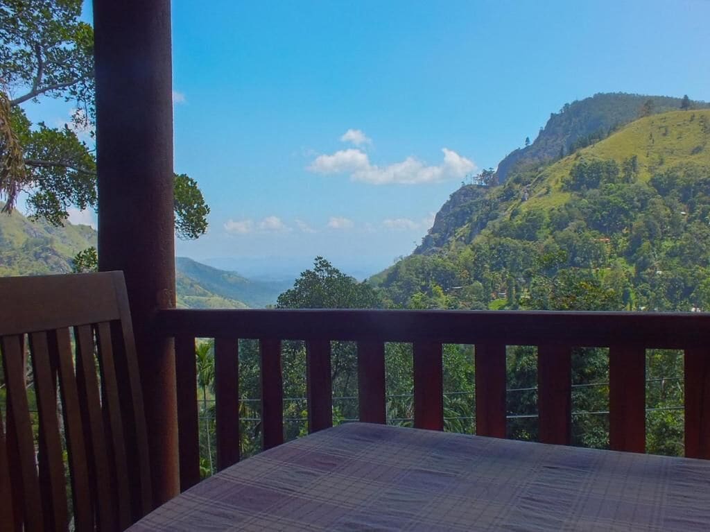 A balcony with a view of a mountainous landscape.
